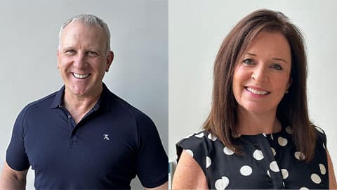 A headshot of Martin and his wife Sharon. He is wearing a navy t-shirt and Sharon is wearing a polka dot top in navy. They are both smiling at the camera.
